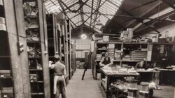 Parts Room & Workbenches Organized component shelving, stock drawers, and workbenches, ca. 1930s.