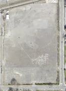 Cleared Site (2021 Aerial Imagery) Modern satellite view of the cleared 95 Ames Street parcel; outlines of the factory foundations and rail spur remain visible.