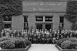 The Factory Frontage (Nos. 59–99) Early panoramic staff gathering assembled along the main manufacturing entrance on Ames Street.