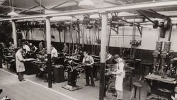 Machine Shop & Lathe Department Ames Street plant, ca. 1930s. Multiple machinists at belt-driven stations.