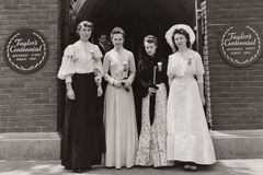 Centennial Reception Committee (1951) Committee hostesses dressed in 1851 period gowns welcoming visitors at the Ames Street entrance.